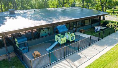 Elevated view of an outdoor enclosed daycare play area.