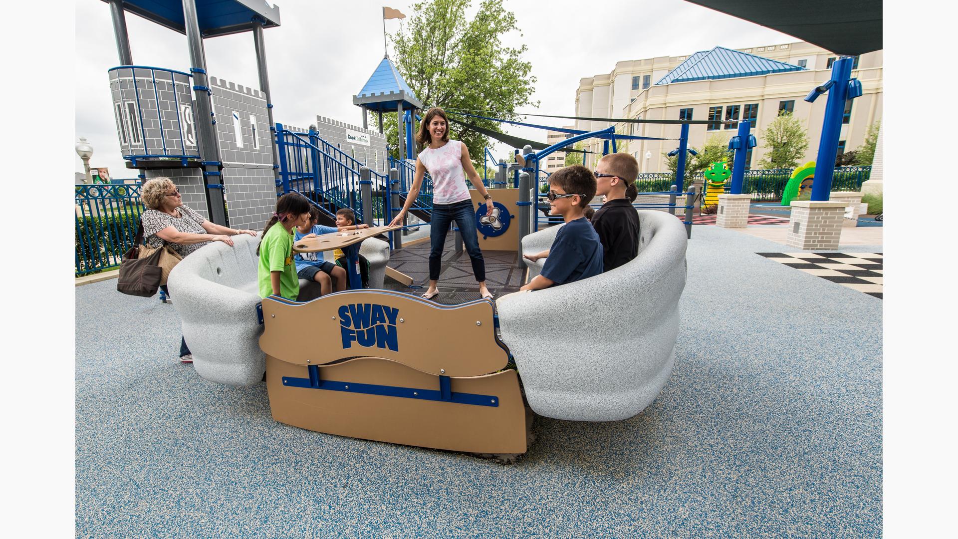 People smiling as they ride the Sway Fun® Glider (16")