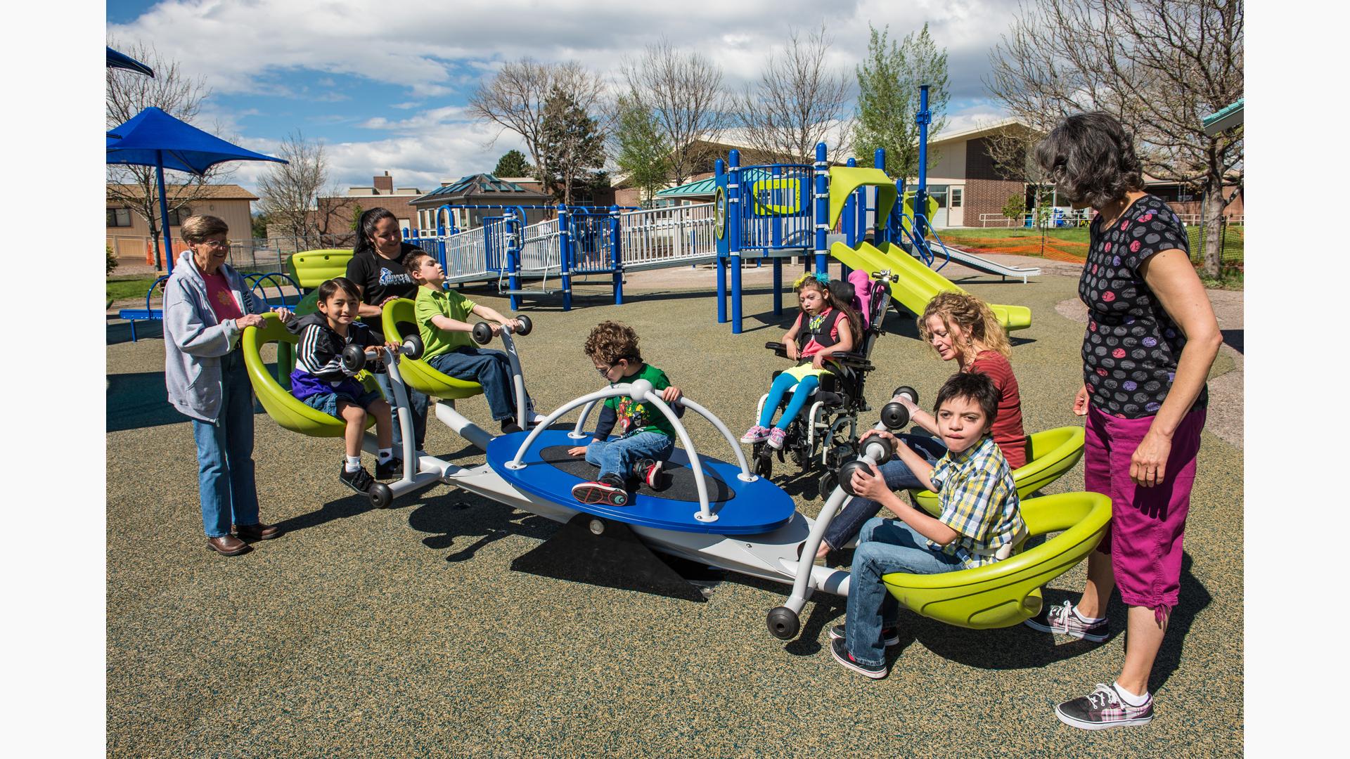 Children of Fletcher Miller School play on a We-saw™ with their teachers.