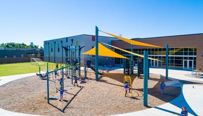 Children play on a sunny day at Positive Tomorrows playground