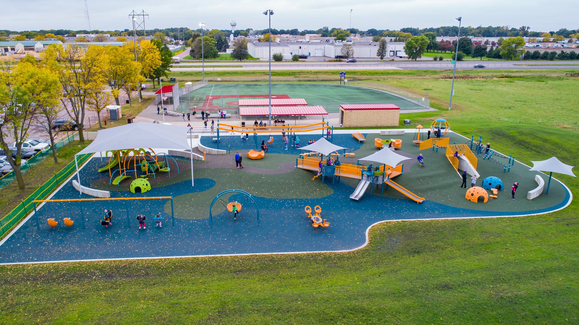 North Mankato Fallenstein Playground and Miracle League North Mankato, MN.  The playground area includes PlayBooster® and Weevos® play structures. There are loads of freestanding play components including the ZipKrooz®, Global Motion®, Sway Fun® glider, We-Saw™ and Cozy Dome® among others. Plus, a custom playground net climber as well.