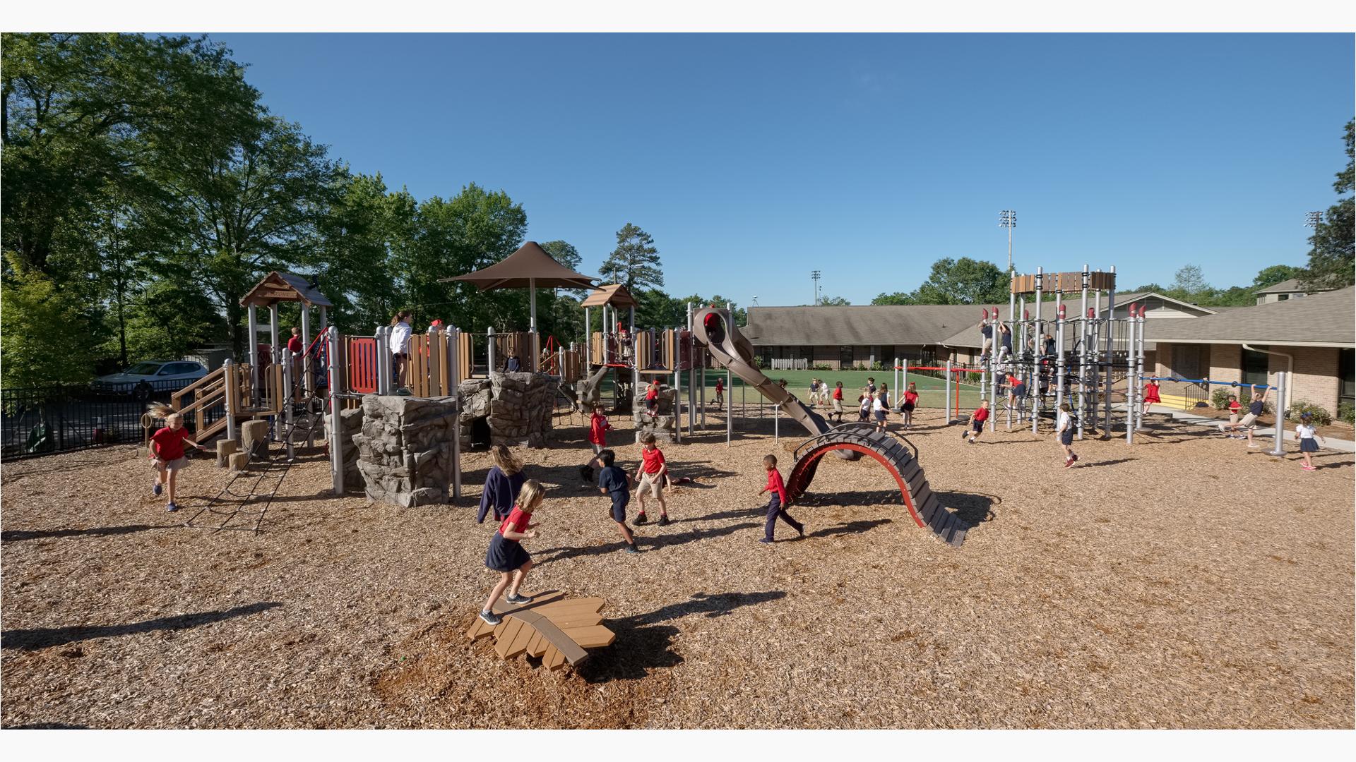 Children at Hammond School playing on this nature-inspired playground. The PlayBooster play structure is packed with kids, while the Netplex is overrun with active kids.