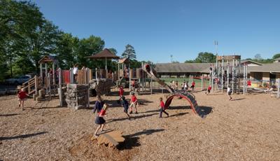 Children at Hammond School playing on this nature-inspired playground. The PlayBooster play structure is packed with kids, while the Netplex is overrun with active kids.