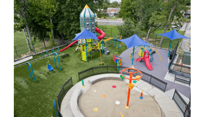 Aerial view of a park playground with a spaceship themed play tower.