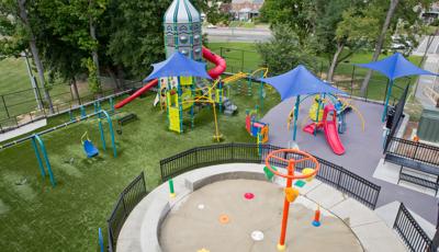 Aerial view of a park playground with a spaceship themed play tower.