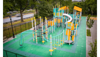 Elevated view of a park playground with bright aqua and yellow accents.