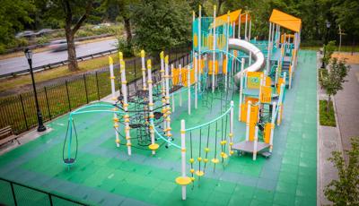 Elevated view of a park playground with bright aqua and yellow accents.