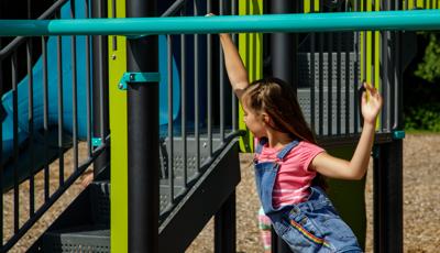 Girl swings on Horizontal Ladder