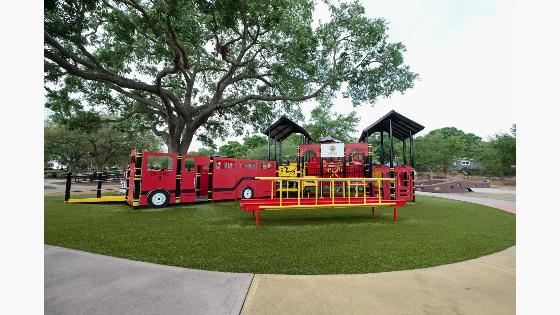 View of Roller Table™ with custom fire truck play structure in the background