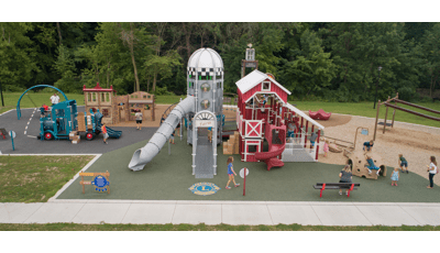 Custom farm-themed PlayBooster playground has two towers and a pickup truck-shaped slide for kids to ride down or climb on.