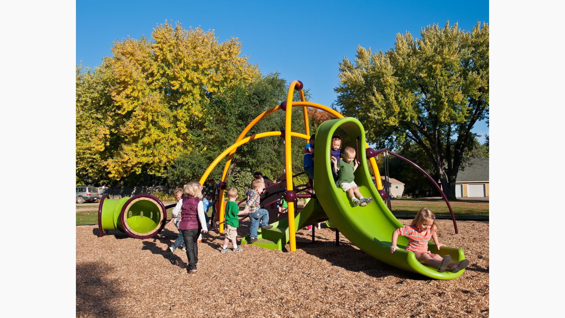 Toddlers swarm over the Weevos play system in St. Joseph's Youth Center. A long line of children forms for the slide.