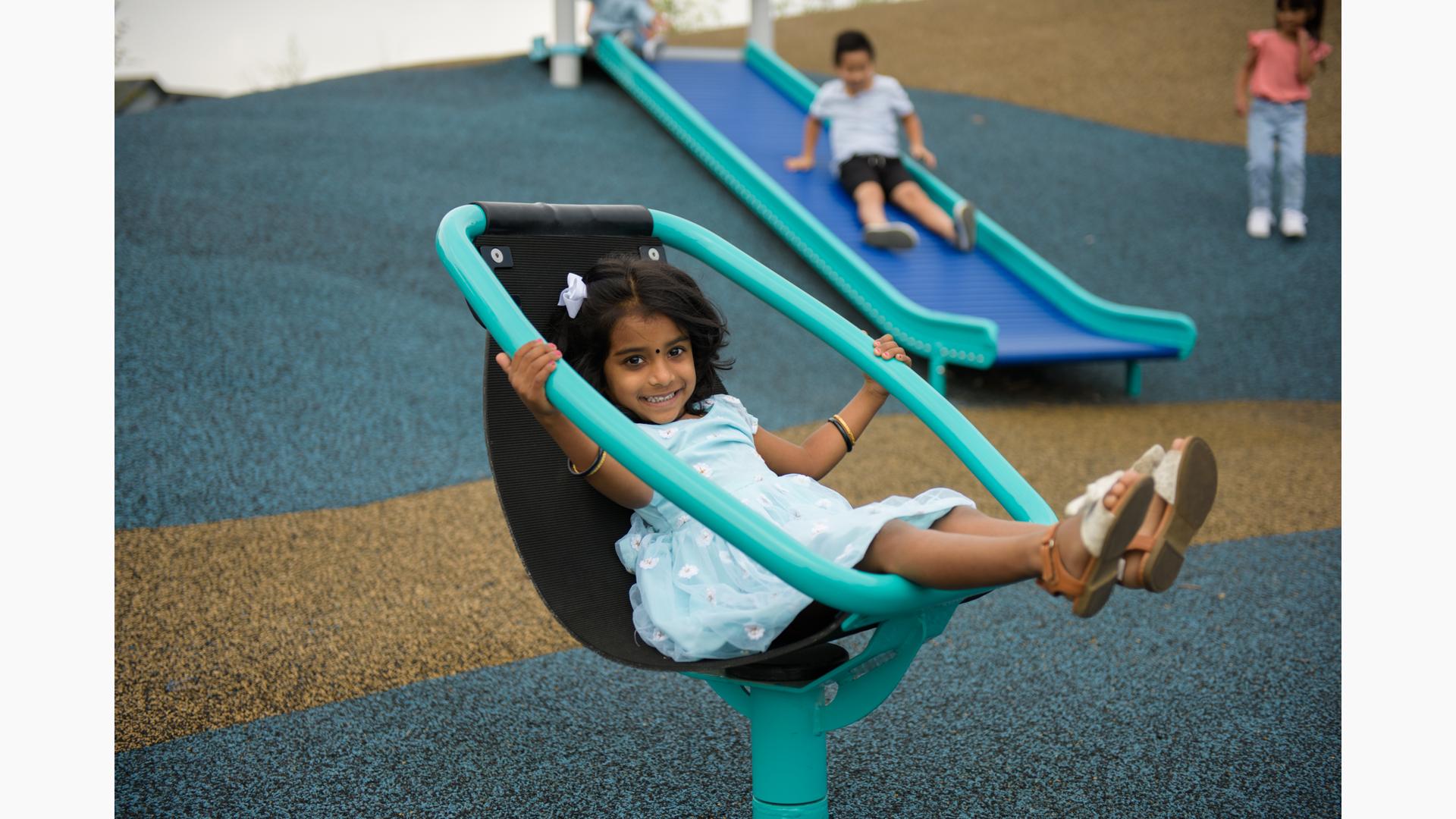 Girl in dress sitting on Chill® Spinner