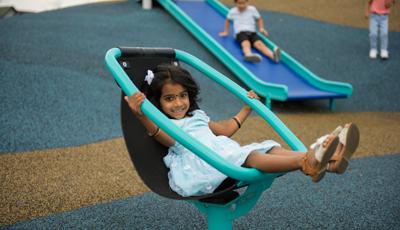 Girl in dress sitting on Chill® Spinner