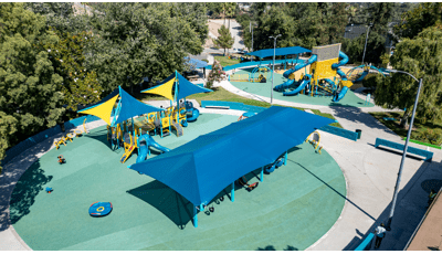 Elevated view of a play area with two separate circular play locations designed with the colors of blue and yellow.