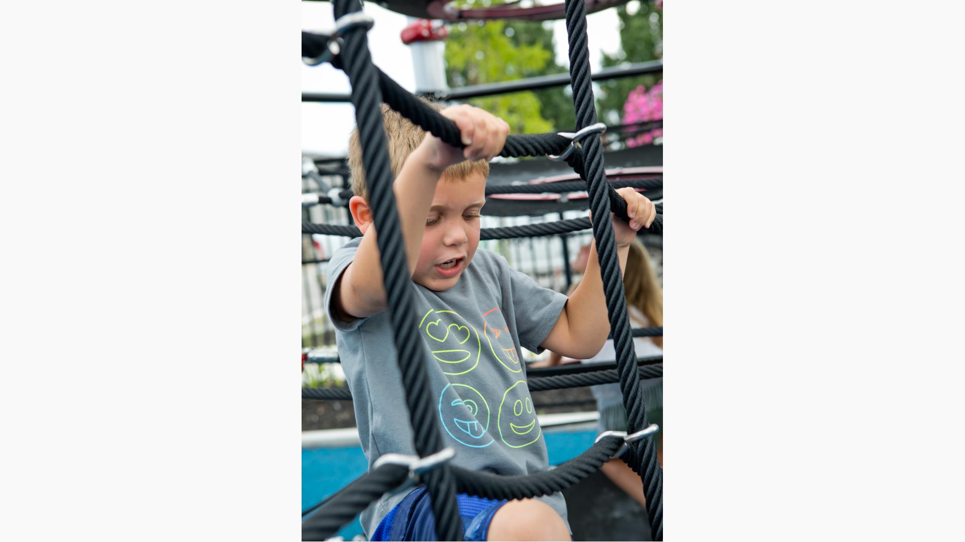 Boy climbing net