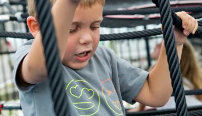 Boy climbing net