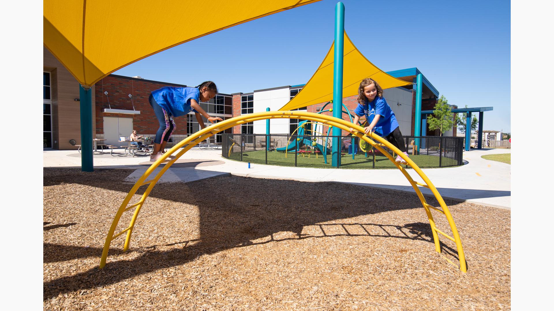 Girls climbing on arch overhead event