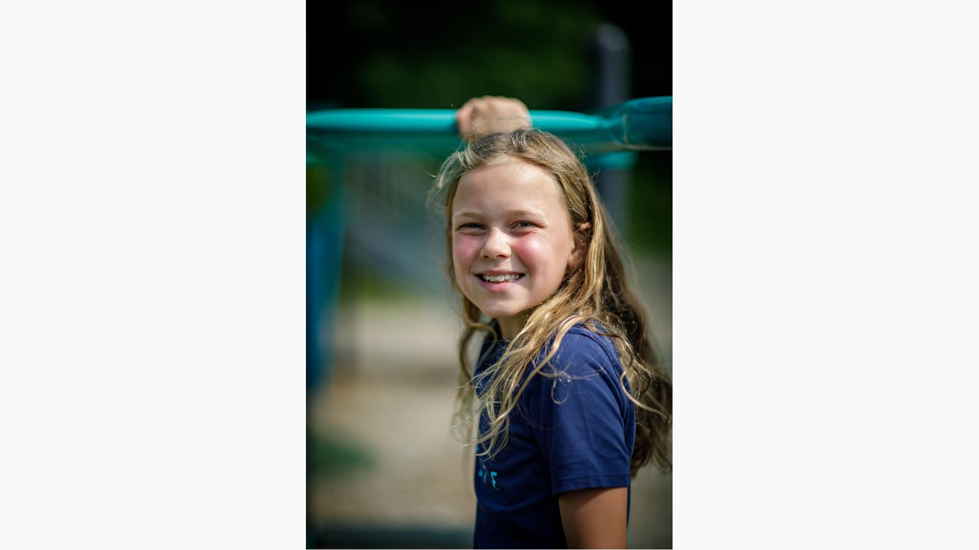 Girl in blue shirt smiling