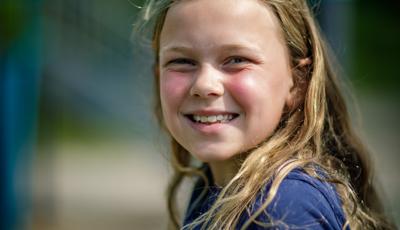 Girl in blue shirt smiling