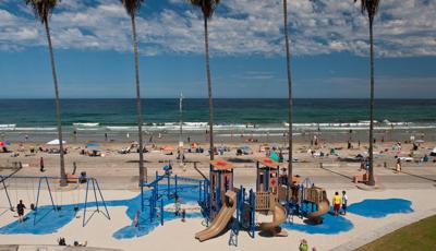 Kellogg Park in La Jolla, CA. A beach-themed PlayBooster® playstructure for ages 5 to 12. Playground features Custom play panels and signage against the background of the pacific ocean.