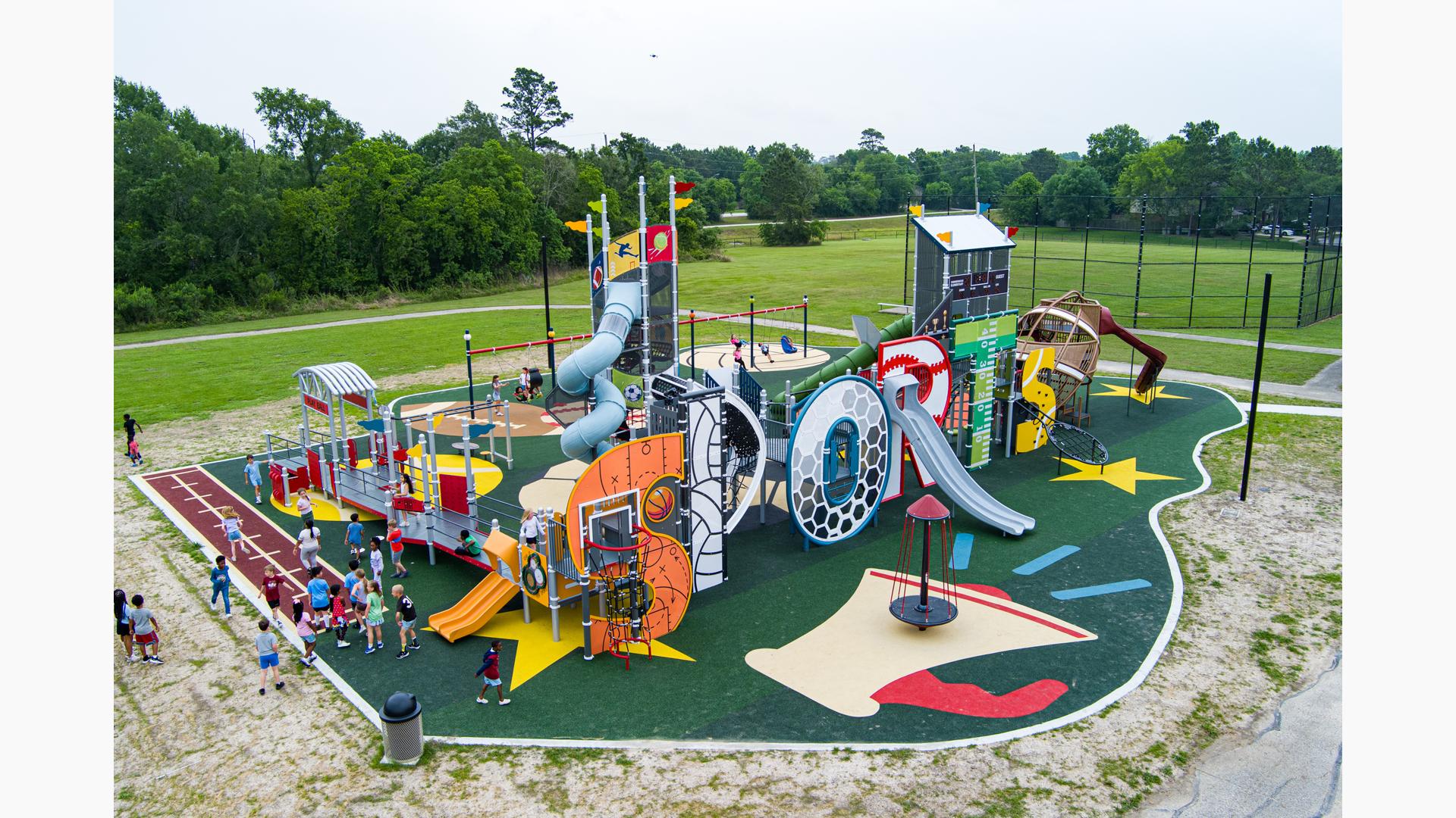 Elevated view of a sports themed playground where the letters of "Sports" makes up the main play structure.
