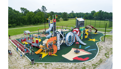 Elevated view of a sports themed playground where the letters of "Sports" makes up the main play structure.