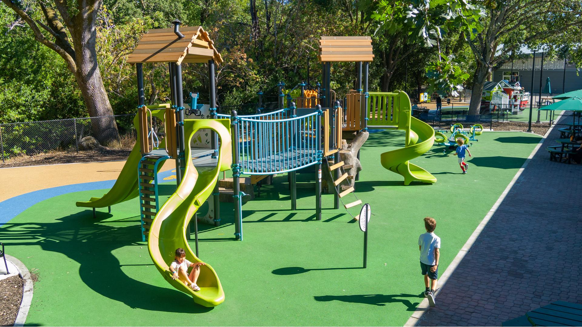 Elevated view of children playing on a park playground.