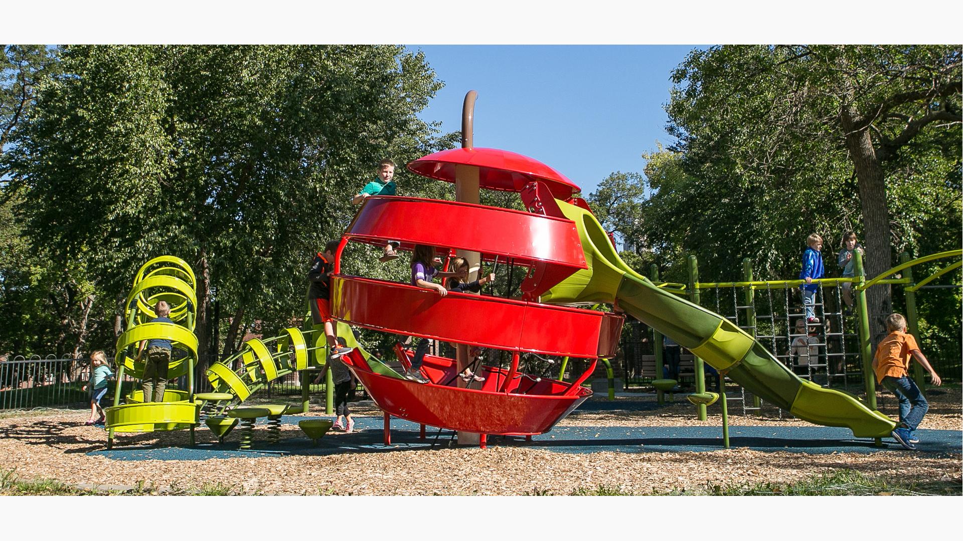 The unique playground design at Stevens Square Park introduces the concept of playable art to the neighborhood. The apple and worm-themed climbers allows children to climb inside the worm, through the apple and out the slide on the other end.