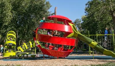 The unique playground design at Stevens Square Park introduces the concept of playable art to the neighborhood. The apple and worm-themed climbers allows children to climb inside the worm, through the apple and out the slide on the other end.