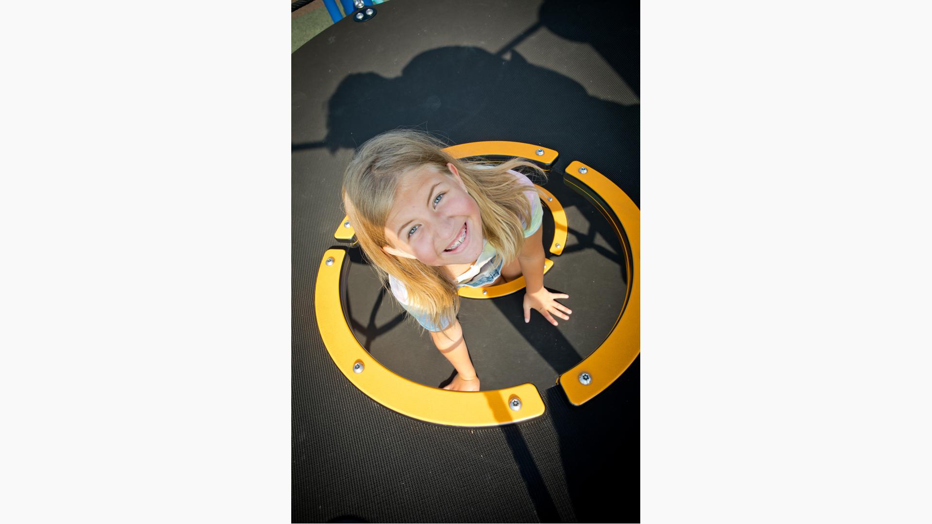 Girl smiling on Netplex play structure