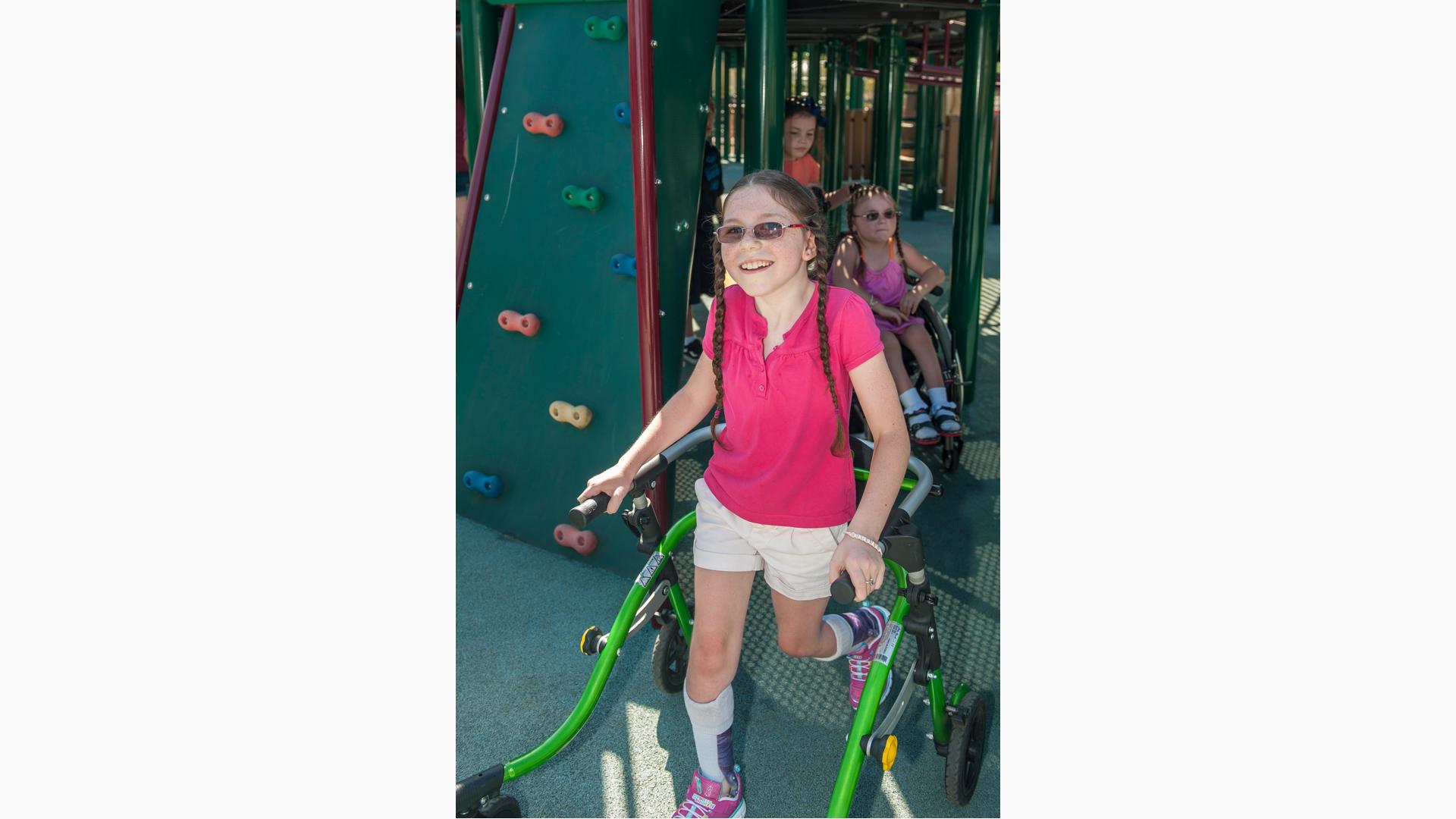 Girl smiles as she walks onto playground