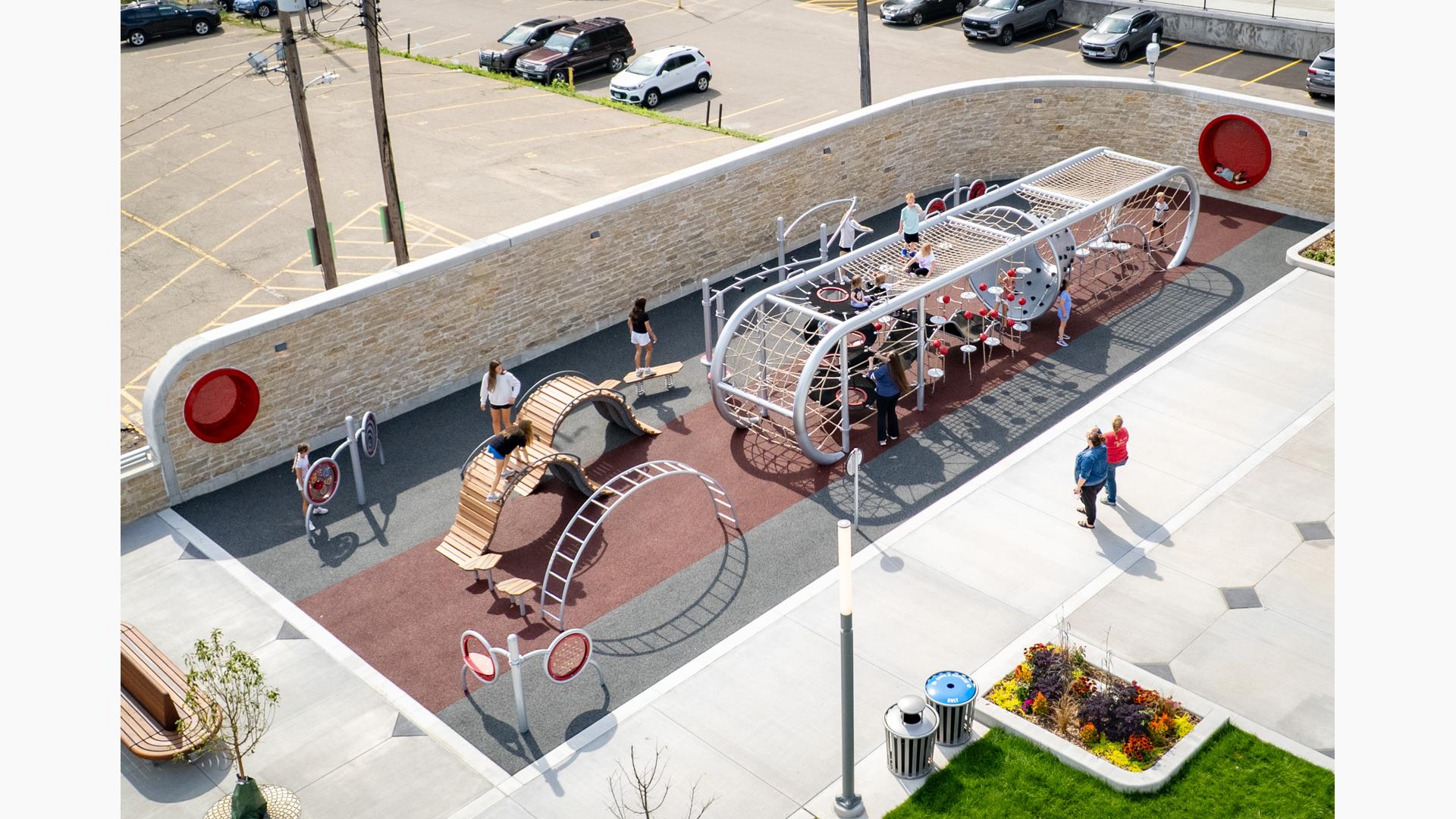 Elevated view of a custom designed playground filled with children.