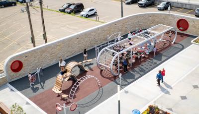 Elevated view of a custom designed playground filled with children.