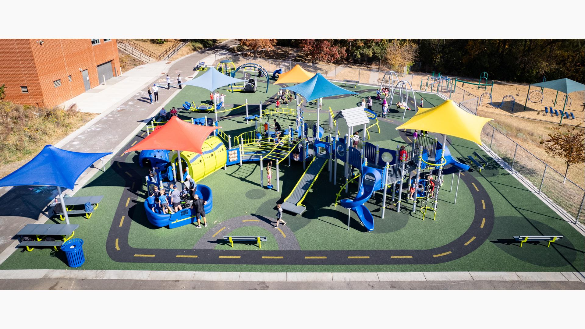 Elevated view of a elementary school playground with road way paths designed into the ground surfacing.