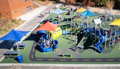 Elevated view of a elementary school playground with road way paths designed into the ground surfacing.