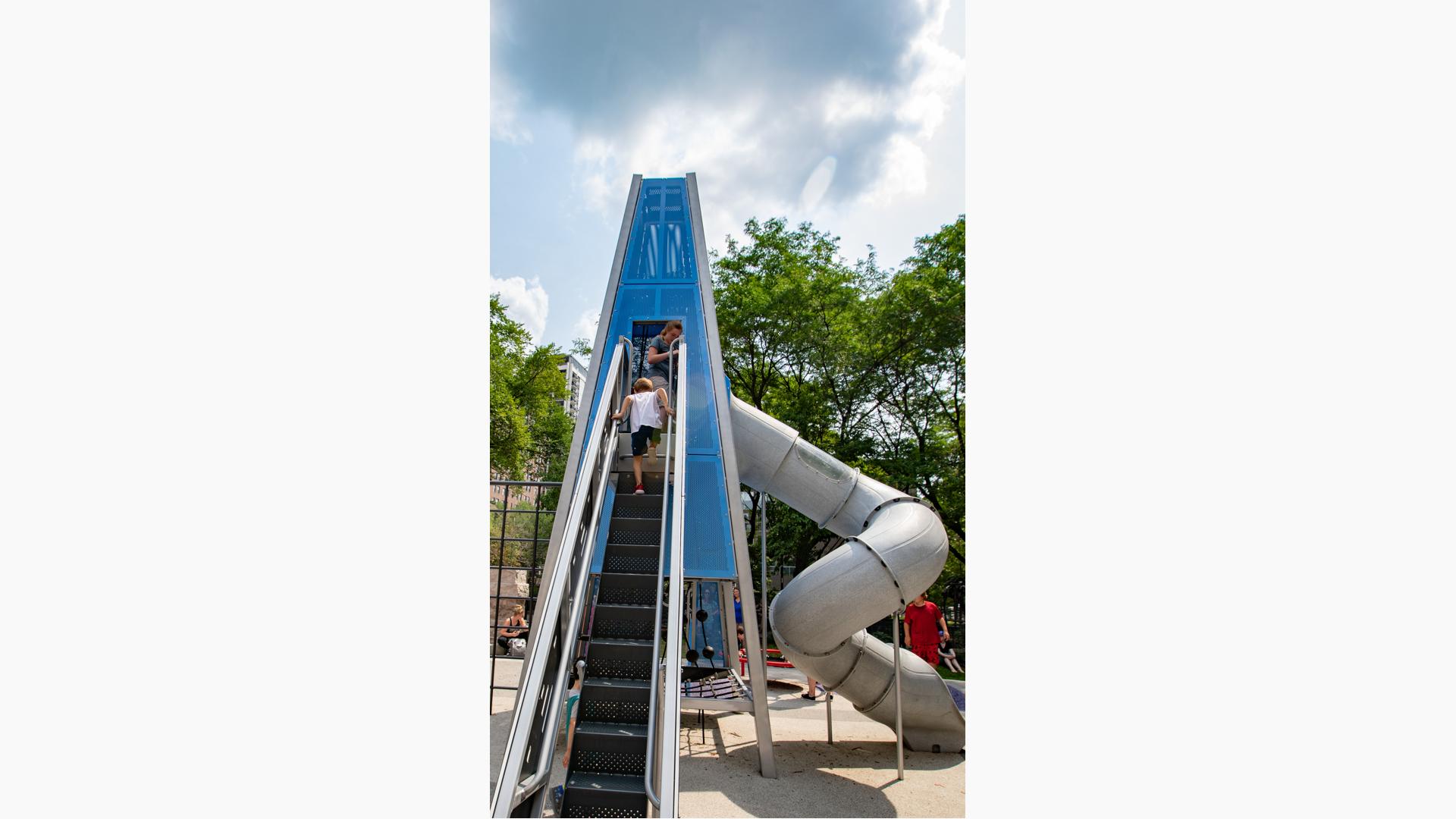 Boy running up stair in custom play structure