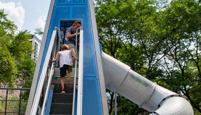 Boy running up stair in custom play structure