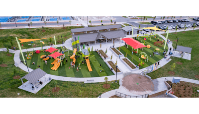 Elevated view of a large half moon shaped play area filled with play structures, swings, and climbers.