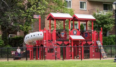  Created to honor and remember local firefighters, is a firehouse- and firetruck-themed PlayBooster® play structure. Surrounded by a black chain-link fence for children's safety and nestled in a New York neighborhood parents can watch their kids imagine life a firefighter from the comfort of their homes surrounding the park.