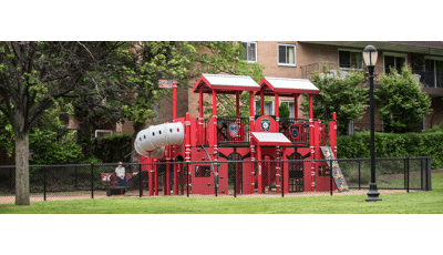  Created to honor and remember local firefighters, is a firehouse- and firetruck-themed PlayBooster® play structure. Surrounded by a black chain-link fence for children's safety and nestled in a New York neighborhood parents can watch their kids imagine life a firefighter from the comfort of their homes surrounding the park.