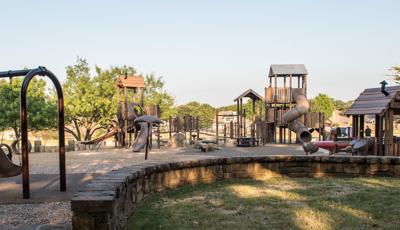 Brown colored, nature-inspired playground equipment.