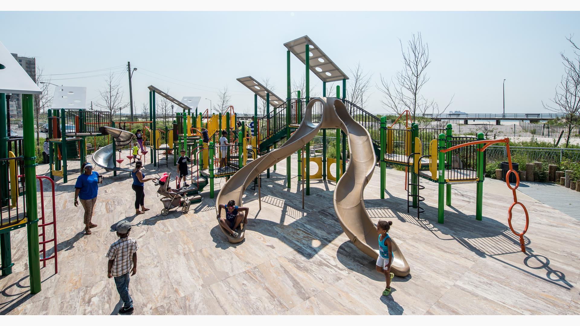Beach 30th Street Playground Rockaway, NY. This customized PlayBooster® play structure features lots of playground slides like the Stainless Steel Spiral Slide, spinners, bridges, and many playground climbers.