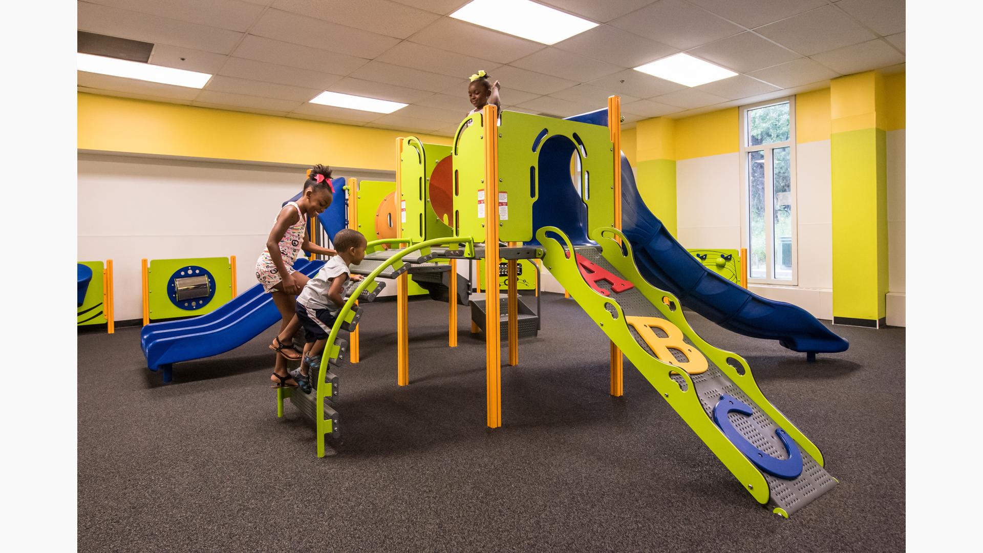 Orland Park Recreation Center, Orland Park, IL featuring a PlayShaper® play structure with a variety of playground climbers like the ABC Climber and slides like the SlideWinder2®.