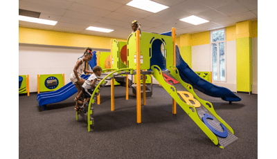 Orland Park Recreation Center, Orland Park, IL featuring a PlayShaper® play structure with a variety of playground climbers like the ABC Climber and slides like the SlideWinder2®.