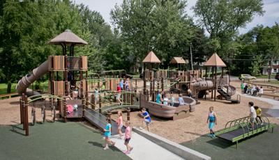 The historic Hamburg Community Playground is a busy place for kids of all ages and abilities with such play features as the Sway Fun, rock climbers from the Canyon Collection, as well as numerous slides and ramps. The Sway fun is packed with kids. Children run across the ramps and check out the many learning panels.