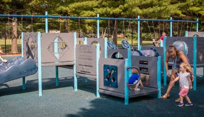 Teacher with kids playing on PlayShaper® play structure. For kids ages 6 to 23 months.