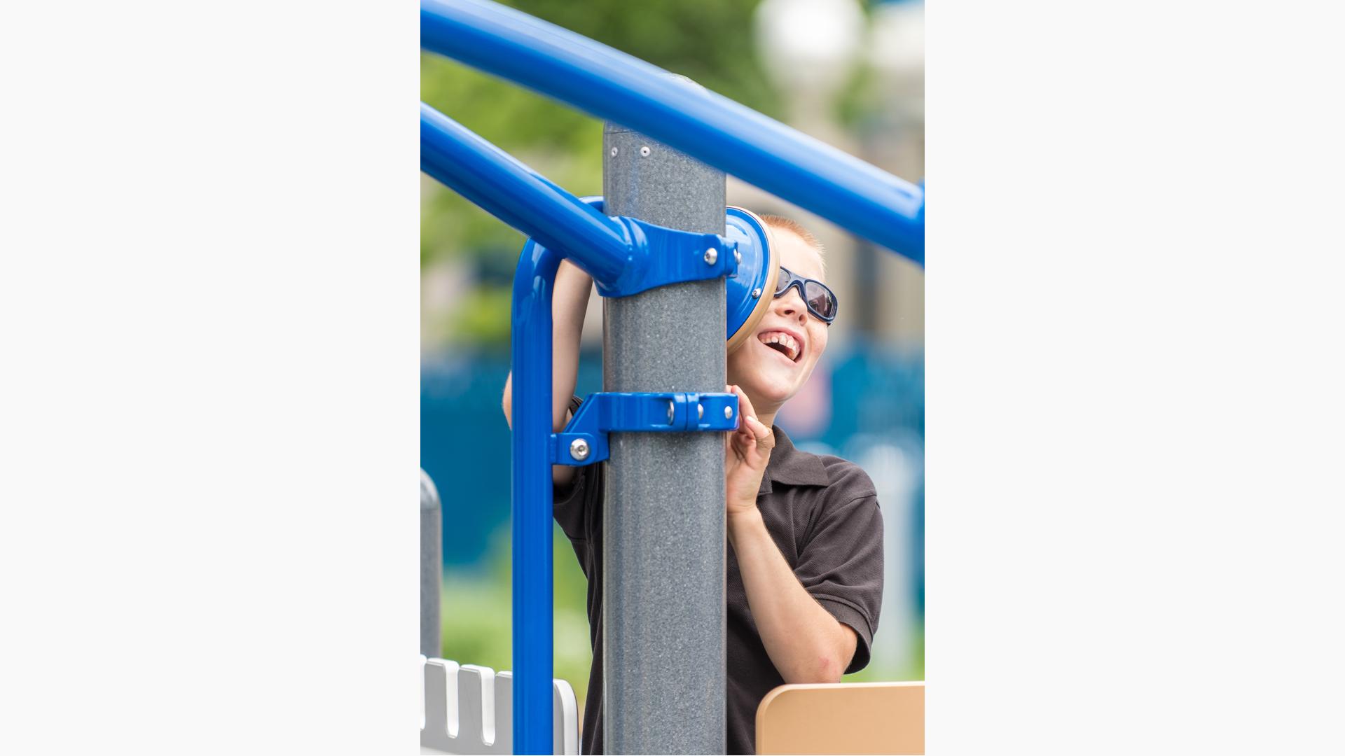 Boy laughing into Talk Tube