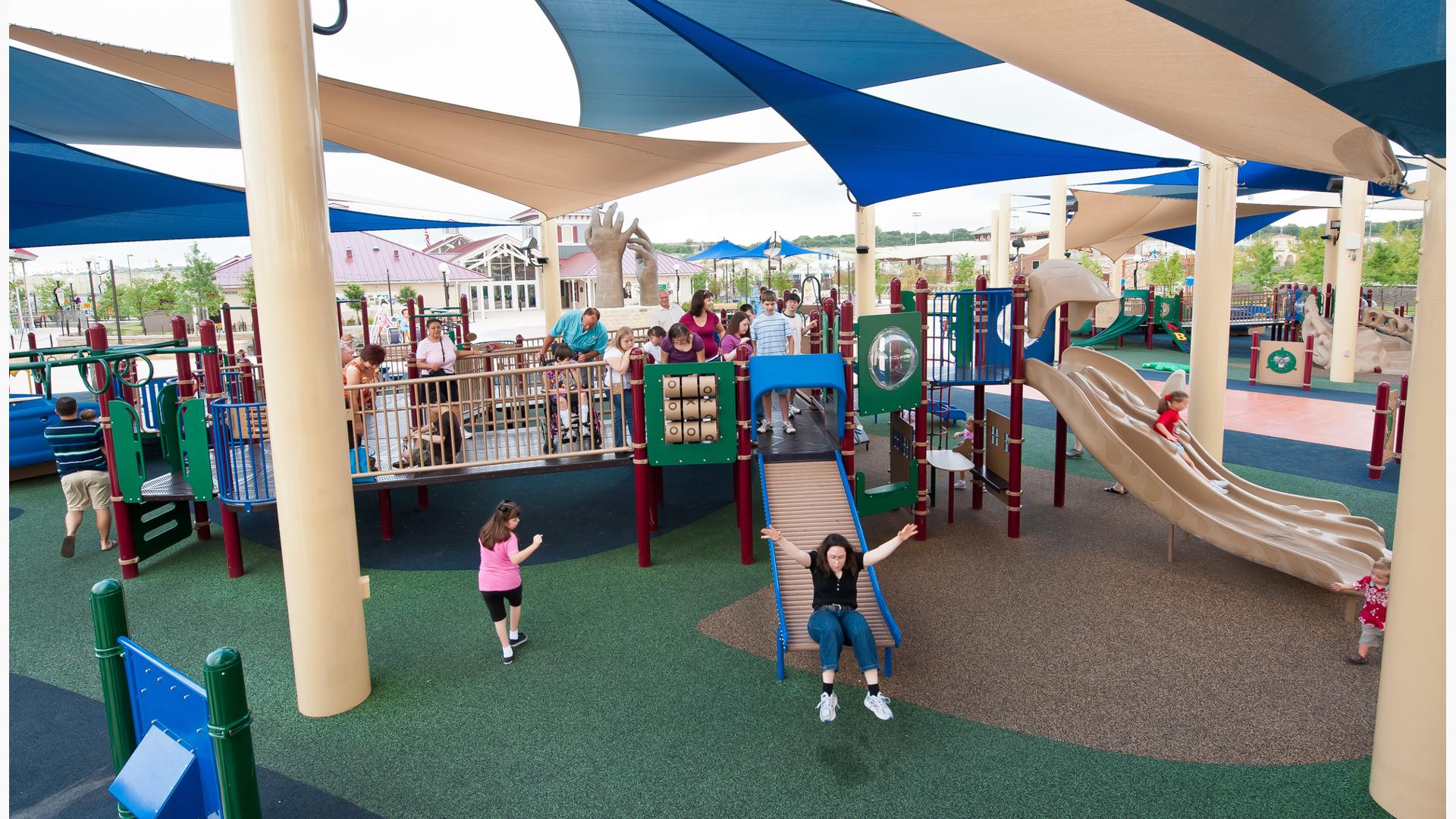 Morgan's Wonderland, San Antonio, TX.  A pirate-themed play area features two inclusive PlayBooster® play structures outfitted with soaring masts and sails.