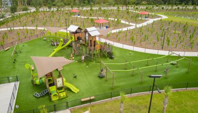 Elevated view of play structures designed like tree houses and other surrounding play activities.