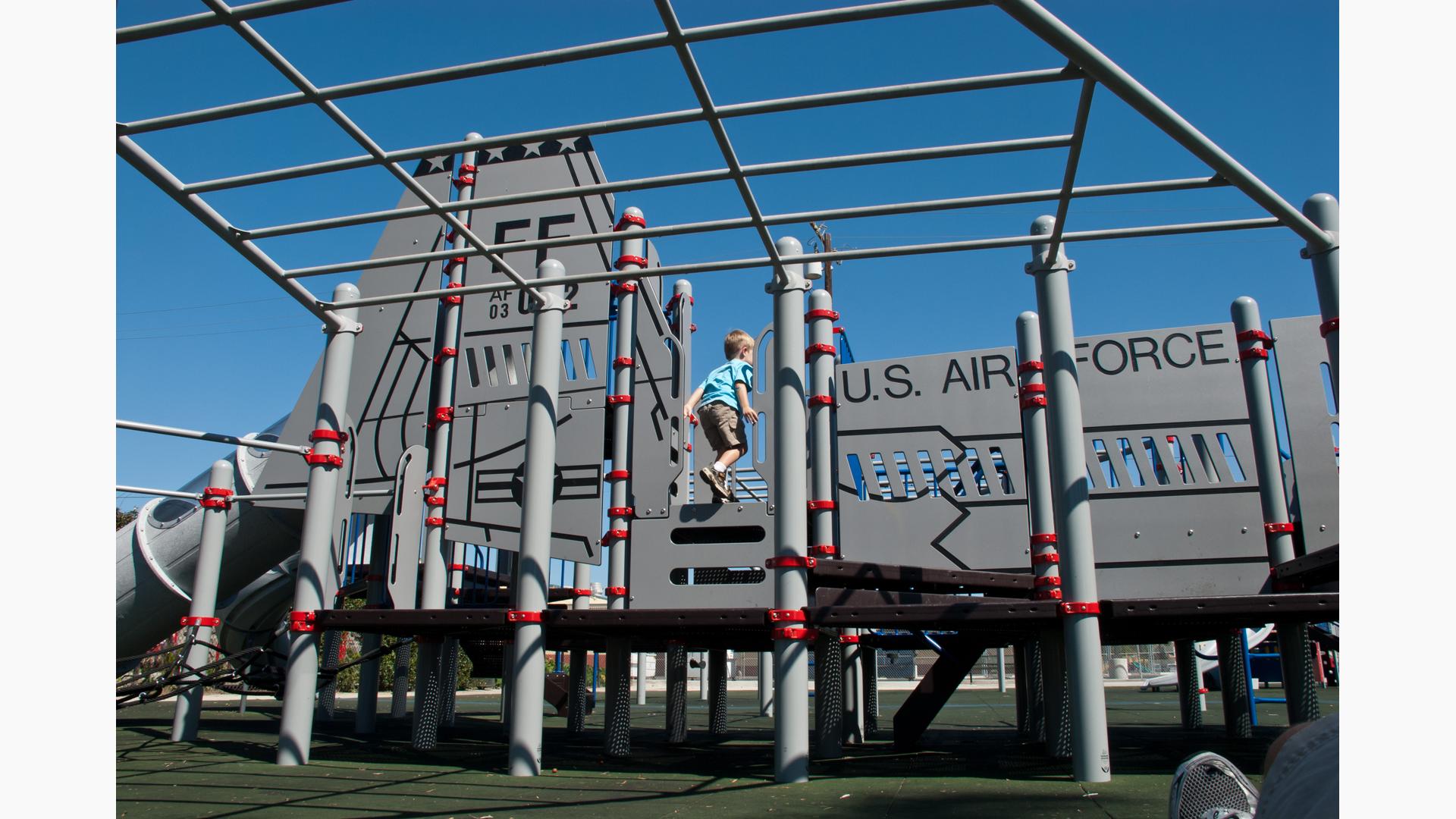 Boy running on custom F-6 fighter jet play structure